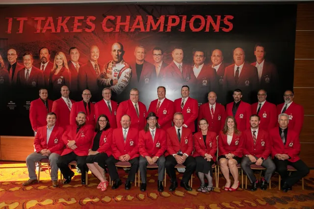 Bryant Circle of Champions dealers gathered in front of an “It Takes Champions” banner