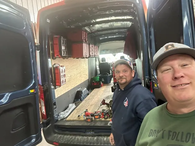 Two Mankato Heating & Cooling team members with a tool-loaded service van