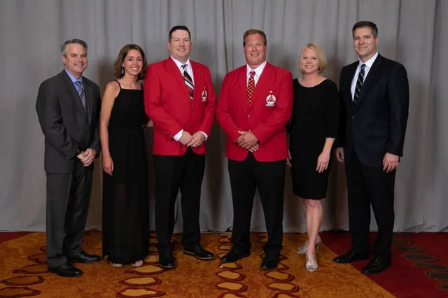 Owners of Mankato Heating & Cooling in red Bryant Medal of Excellence blazers at a Bryant awards gala